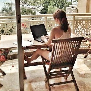 Lorraine Haataia, PhD, Founder Prolific Writers Life writing on laptop in Indonesia